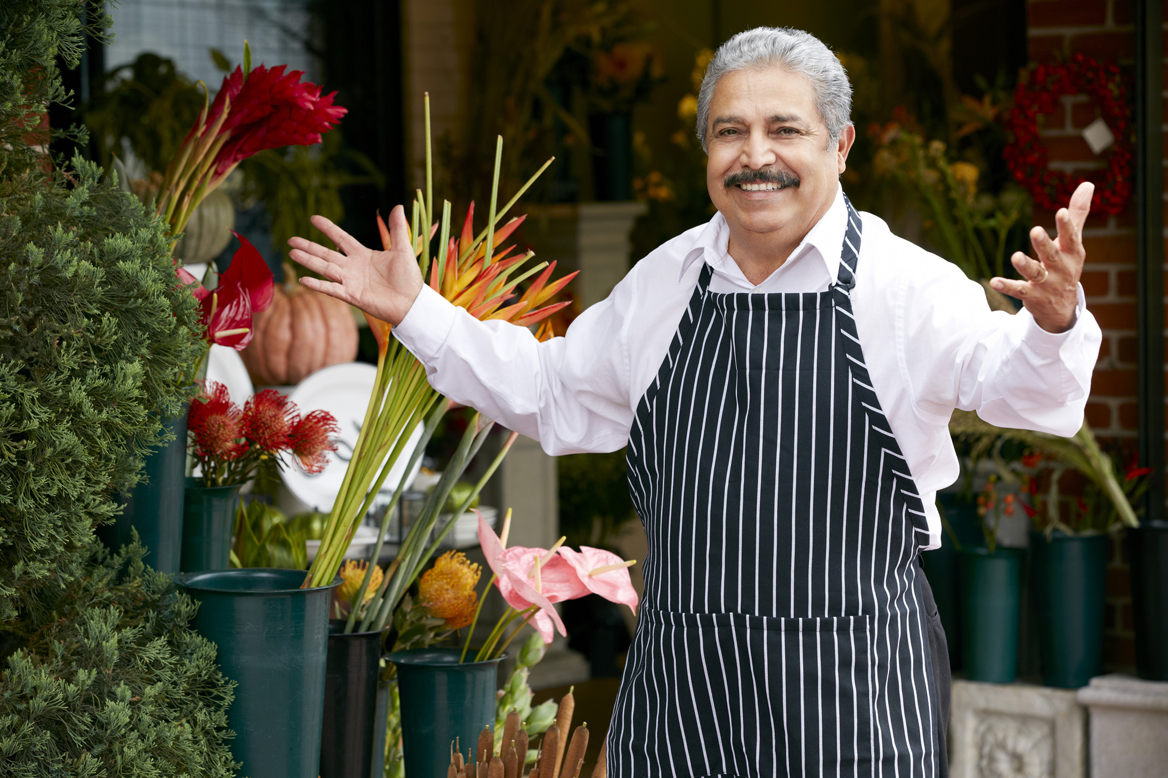 man selling flowers with a warm welcome