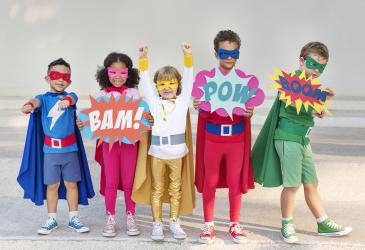 five kids wearing superhero costumes