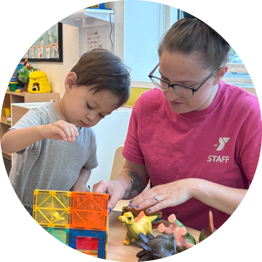 A child care educator working with children in a classroom