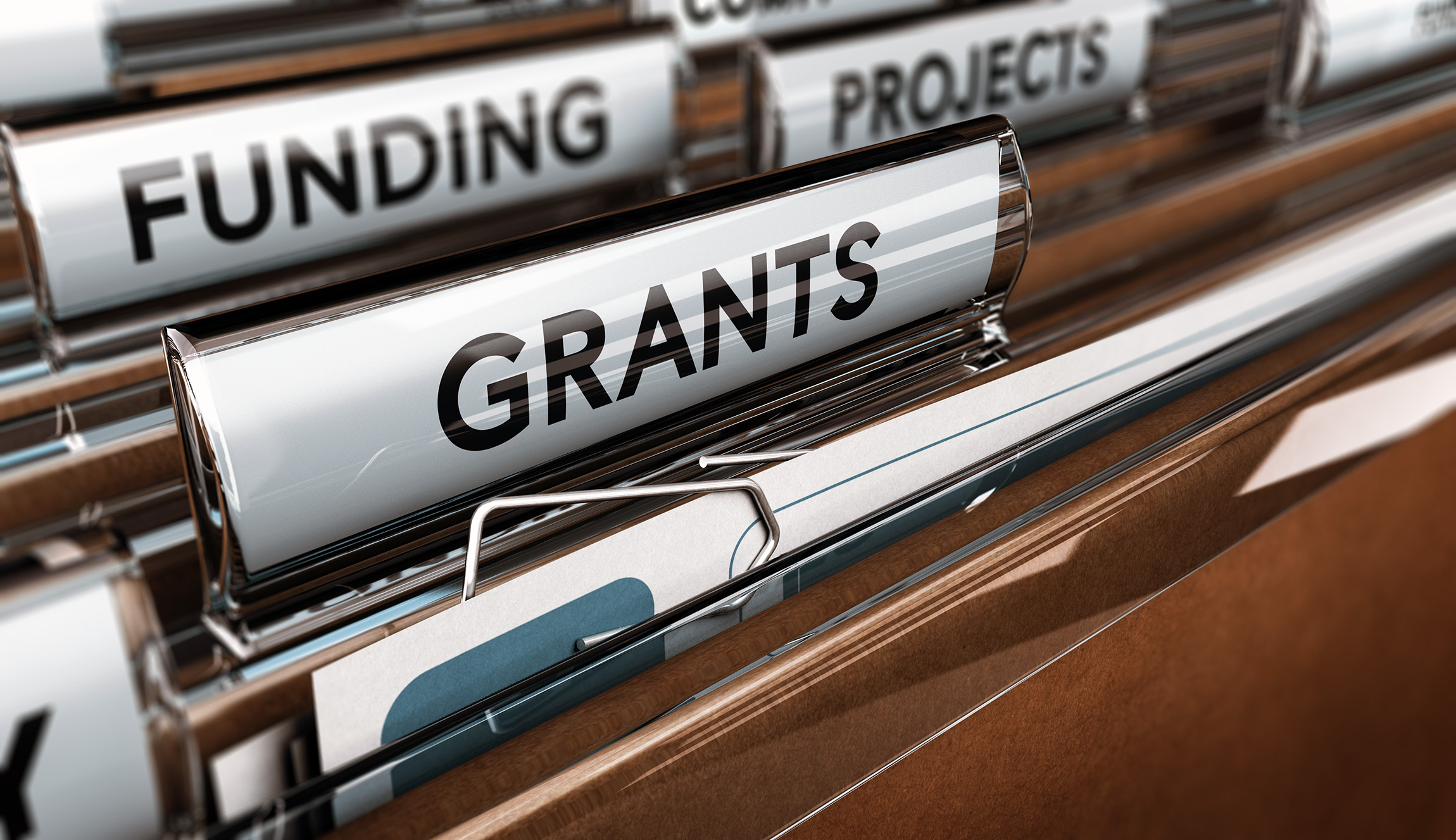 file cabinet drawer opened with file tabs reading funding, projects, grants