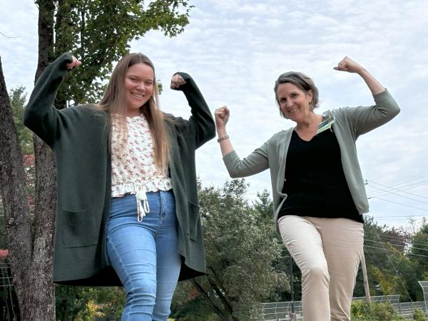 2 women flexing their muscles