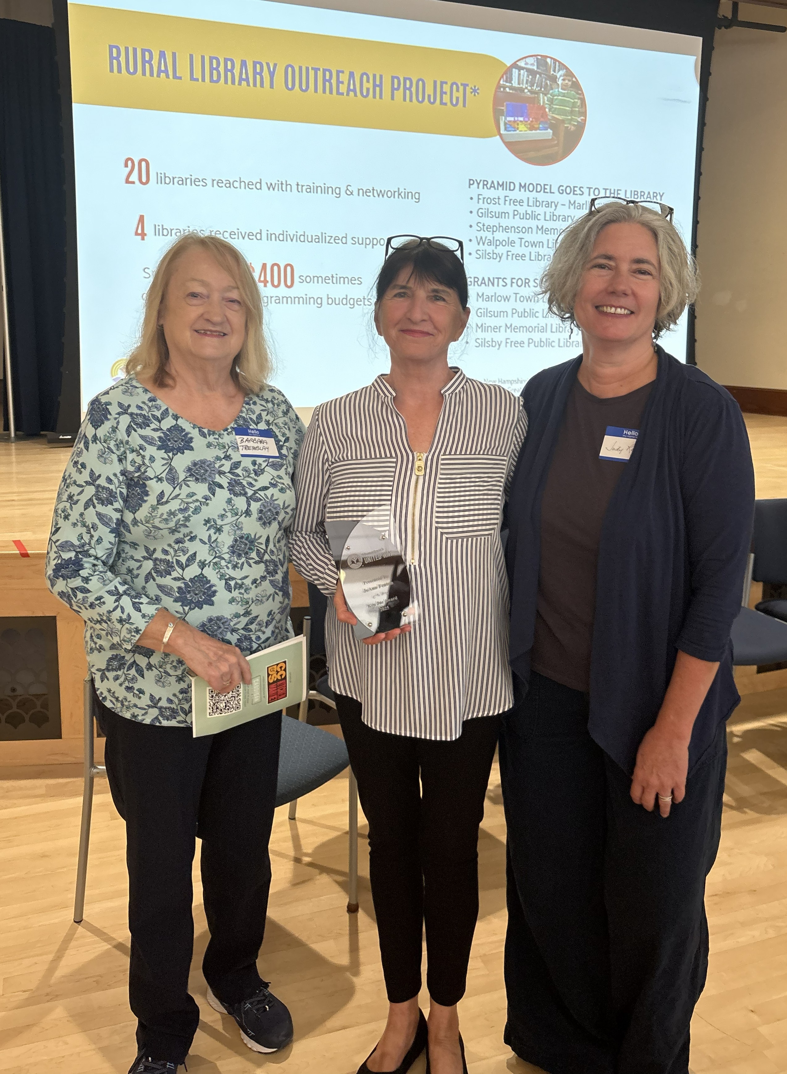 JoAnn Fenton holding award with Barb Tremblay and Judi Rogers beside her