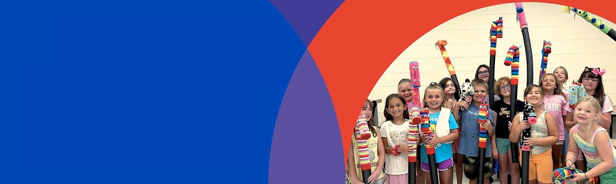 image of children with artwork celebrating Giving Tuesday