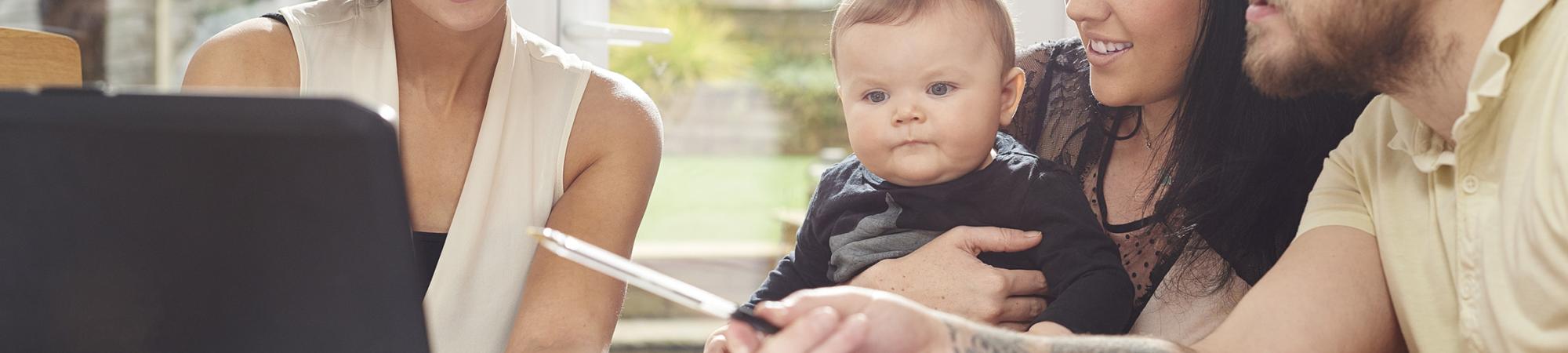 parents with young baby getting financial planning help