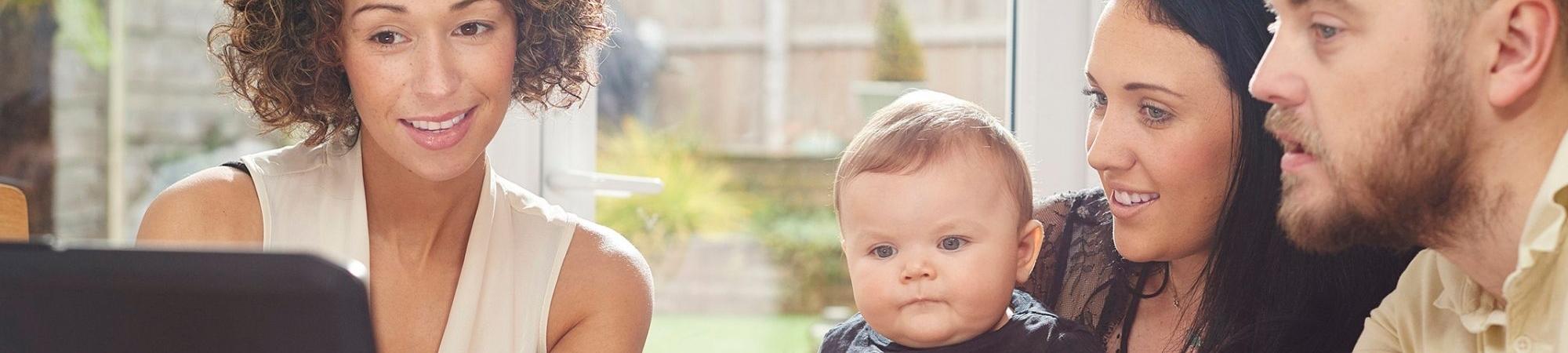 parents with young baby getting financial planning help